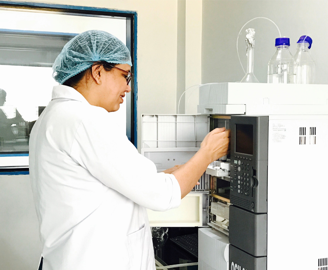 Lab technician testing oil quality on analytical equipment